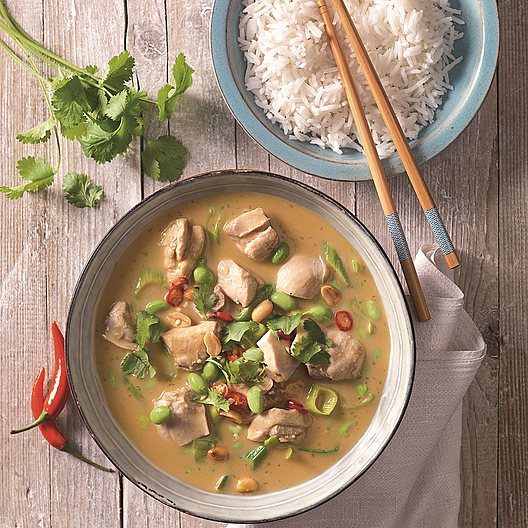Asia-Gemüse und Fleisch mit Reis und Stäbchen in einer Schüssel angerichtet